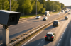 Fotoradars uz Latvijas autoceļa fiksē transportlīdzekļu ātrumu saulainā dienā.